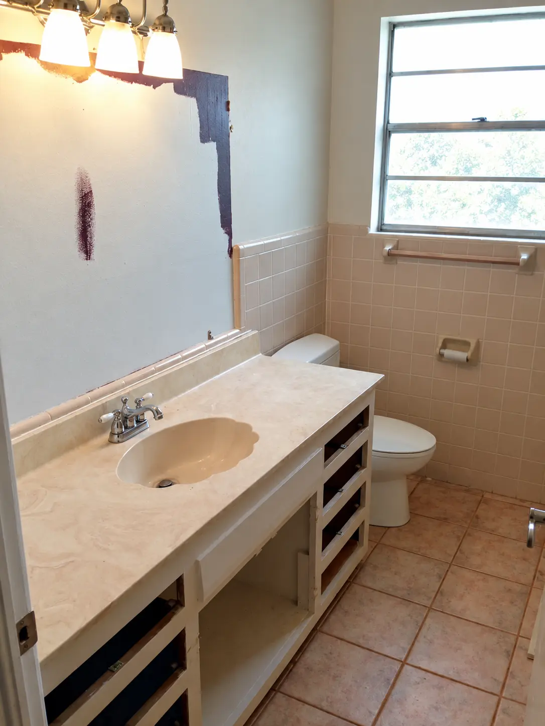 Bathroom before the remodel, with the old vanity and tile