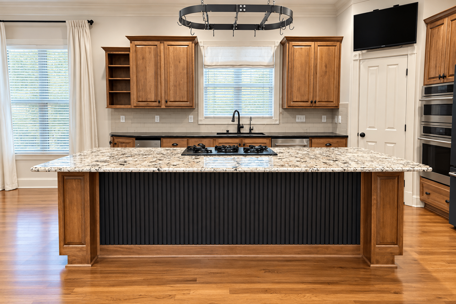 Completed kitchen island with stone worktop and dark paneled face